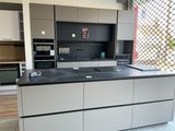 a kitchen with a black counter top and white cabinets