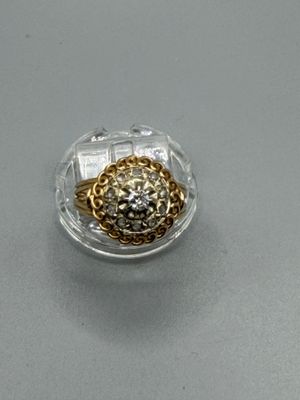 a gold and silver ring with a diamond in it