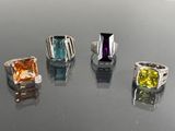 four different colored stones are arranged in a row on a table