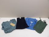 four pairs of men ' s shorts on a white table
