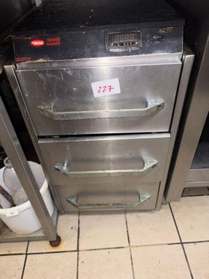 a silver oven sitting in the middle of a kitchen