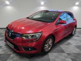 a red car is parked in a room with a checkered floor