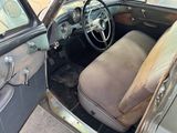 an old car that is sitting in the garage