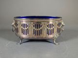 an antique silver and blue glass bowl on a stand