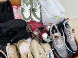 many pairs of shoes in a box on the floor