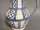 un vase bleu et blanc posé sur une surface grise