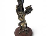 a statue of a man holding a vase on a base