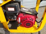 a small engine on the side of a yellow cart
