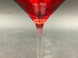 a wine glass with a red liquid inside of it