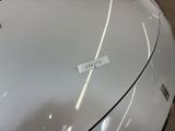 a sticker on the hood of a white car