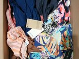 a box full of clothes that is sitting on the floor