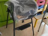 a chair that has a plastic bag on top of it