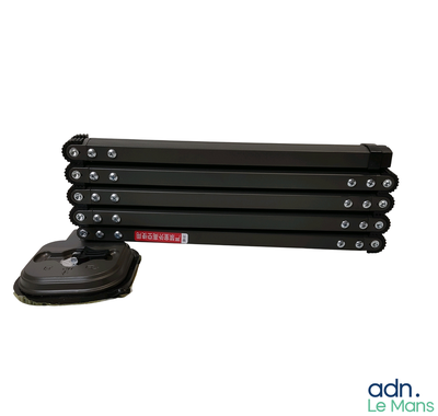 three black rollers with wheels and a rubber pad on a white background
