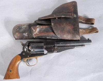 an old revolver with a leather holster on a white background