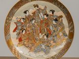 a plate with a picture of a group of people on it