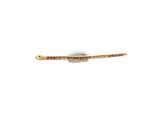 a close up of a gold plated hair clip with red and white stones