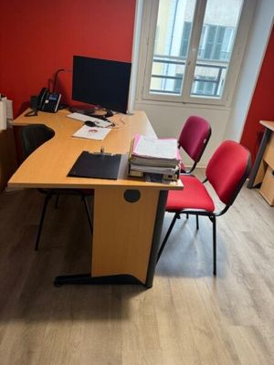 a desk with two chairs and a computer on top of it