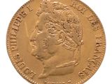 a close up of a gold coin with a woman ' s head on it