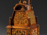 an old wooden clock with a star design on the front