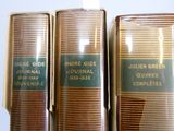 trois livres sont alignés les uns à côté des autres sur une étagère