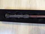 a wooden stick in a black box on a wooden table