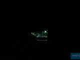 a small boat floating in the water at night