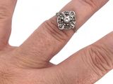 a woman ' s hand with red nails and a ring on it