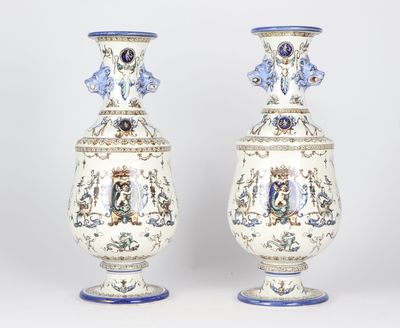 pair of vases with blue and white designs on them sitting on a table