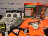 a pile of orange shirts and other items on a table