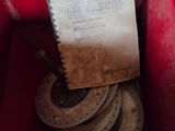 a red box with a bunch of old horseshoes in it