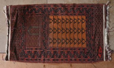 an old rug on the floor with a brown and red design