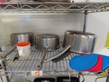 pots and pans sitting on a shelf in a kitchen