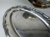 a silver plate with a handle on a table