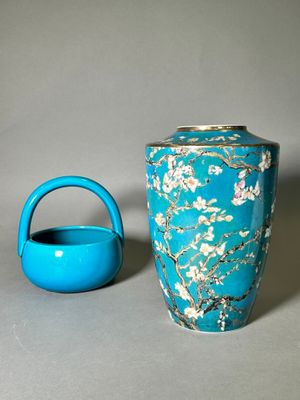 a blue vase and a teapot sitting on a table