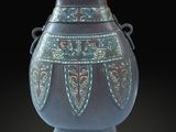 a blue vase that is sitting on a black surface