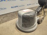 a machine that is sitting on the ground in front of a sign