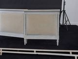 a picture of a white bed frame with a black background
