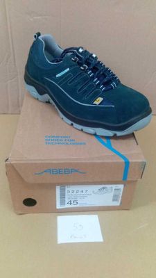 men ' s shoes in a box on a table next to a cardboard box