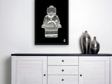 a black and white photograph of a lego man on a black background