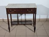 a marble top table with a shelf underneath it
