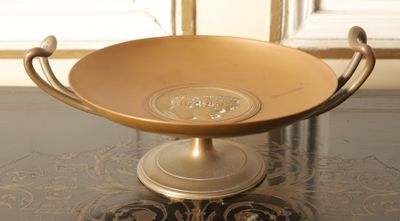 a bowl on a table with a handle on it