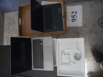 two laptops sitting on top of a table next to each other
