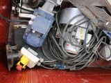 an image of a pile of electrical equipment in a dumpster
