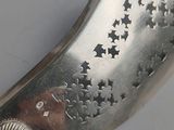 a silver knife with stars on it on a table