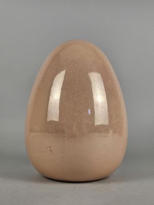 a brown egg that is sitting on a table