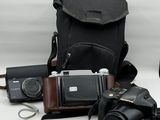 a camera, a camera case, a camera and other items on a table