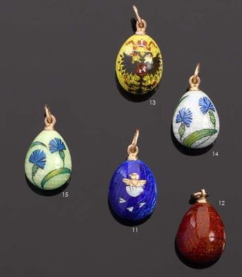 a close up of a group of different colored eggs on a black surface