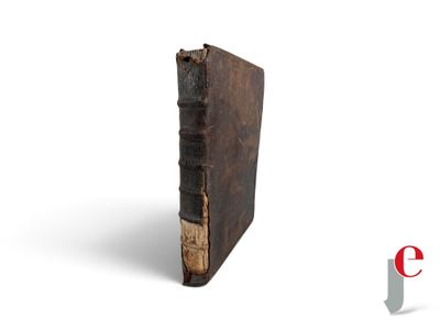 an old book sitting on top of a white surface