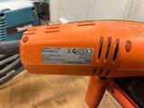 an orange drill with a cord attached to it