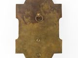 a close up of a brass plate with a ring on it